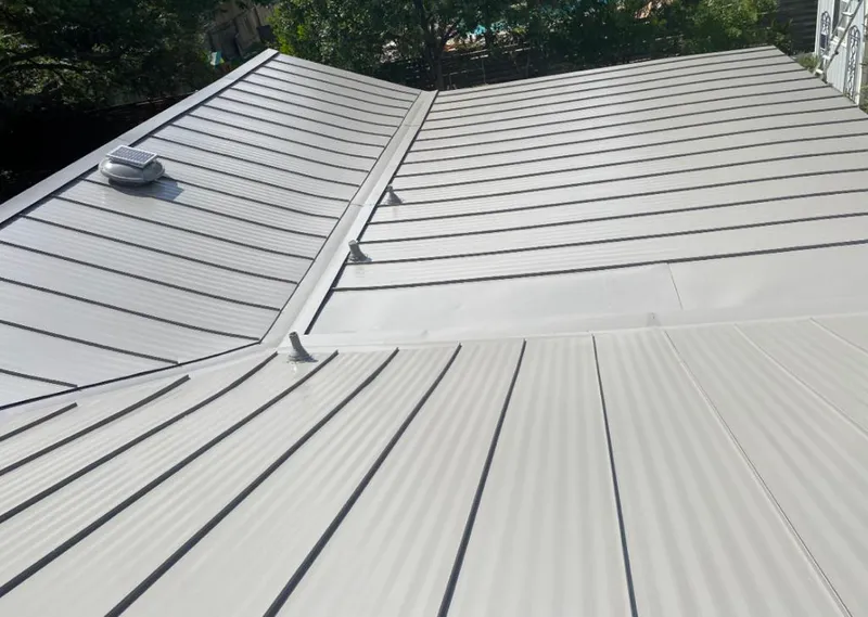 Solar attic fan installed on a metal roof for Roof Ventilation in Kirkland