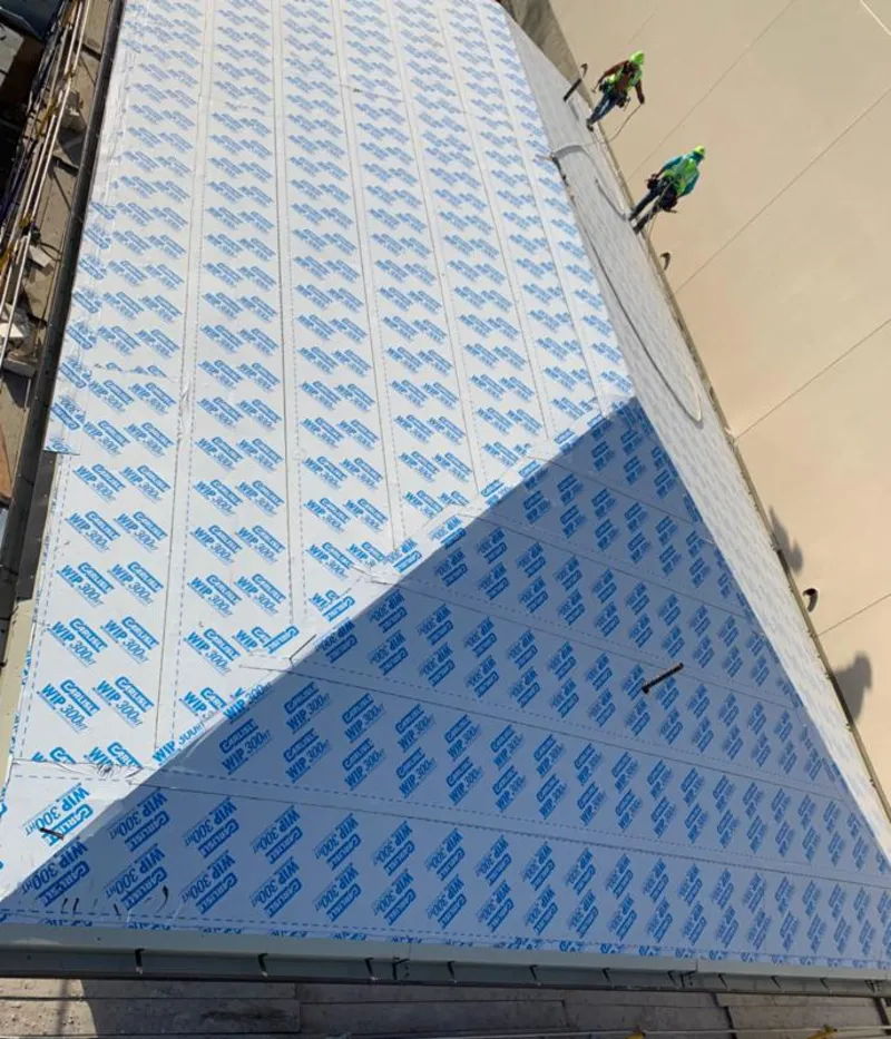 Professional roofers installing underlayment on a metal roof in Kirkland